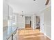 Open concept kitchen area with hardwood floors leading to dining and laundry areas at 6309 Charmco Ct, Wake Forest, NC 27587