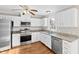 Well-equipped kitchen featuring stainless steel appliances, granite countertops, and white cabinetry at 6309 Charmco Ct, Wake Forest, NC 27587