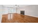 Bright living room with hardwood floors, a brick fireplace, and built-in bookshelves at 6309 Charmco Ct, Wake Forest, NC 27587