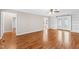 Open living space featuring hardwood flooring and built-in shelves, creating a cozy atmosphere at 6309 Charmco Ct, Wake Forest, NC 27587