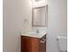Clean bathroom with wood vanity, modern mirror, and white toilet at 650 Ganyard Farm Way # 13, Durham, NC 27703