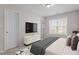 Bright bedroom featuring a flat-screen TV, large window and neutral decor at 650 Ganyard Farm Way # 13, Durham, NC 27703