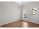 Bright bedroom with hardwood floors, ceiling fan, window, and door to the exterior at 650 Ganyard Farm Way # 13, Durham, NC 27703