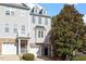 Attractive townhome exterior with stone accents, dormers, and lush landscaping at 650 Ganyard Farm Way # 13, Durham, NC 27703