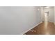 Clean hallway with hardwood flooring and neutral paint, leads to other rooms at 650 Ganyard Farm Way # 13, Durham, NC 27703
