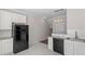 Bright kitchen featuring stainless steel sink, black appliances, and granite counters at 650 Ganyard Farm Way # 13, Durham, NC 27703