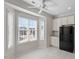 Eat-in kitchen area with bright windows, ceiling fan, and black refrigerator at 650 Ganyard Farm Way # 13, Durham, NC 27703