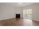 Living room featuring hardwood floors, fireplace, and sliding doors at 650 Ganyard Farm Way # 13, Durham, NC 27703