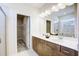 Bathroom featuring double sinks, modern cabinets, and a walk-in shower at 68 Victory View Ter, Smithfield, NC 27577