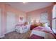 Bright bedroom featuring twin beds with floral comforters and pink walls at 68 Victory View Ter, Smithfield, NC 27577