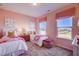 Cozy pink bedroom with two twin beds, patterned window coverings and a view at 68 Victory View Ter, Smithfield, NC 27577