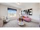 Cozy living room with pink sofa, patterned accents, and bright window at 68 Victory View Ter, Smithfield, NC 27577