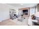 Elegant living room features a modern fireplace, large TV, stylish seating, and chic decor at 68 Victory View Ter, Smithfield, NC 27577