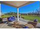 A covered patio area with nice wicker furniture and a beautiful green view at 68 Victory View Ter, Smithfield, NC 27577