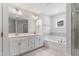 A bright bathroom with double vanity, soaking tub with tile surround, and glass-enclosed shower at 741 Aristocrat Ln, Knightdale, NC 27545
