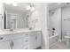 Well-lit Primary bathroom features double sink vanity and shower-tub combo at 741 Aristocrat Ln, Knightdale, NC 27545