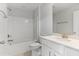 Bathroom with white cabinets, quartz countertop vanity, and shower-tub combo at 741 Aristocrat Ln, Knightdale, NC 27545