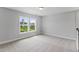 Upstairs bedroom with two large windows overlooking the neighborhood, offering a bright and airy feel at 741 Aristocrat Ln, Knightdale, NC 27545