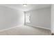 Empty carpeted bedroom featuring recessed lighting and a bright window view at 741 Aristocrat Ln, Knightdale, NC 27545