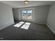 Bonus room featuring neutral carpeting, double windows and calming, neutral-colored walls at 741 Aristocrat Ln, Knightdale, NC 27545