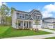 Charming two-story home featuring a well-maintained lawn, covered porch and attached two-car garage at 741 Aristocrat Ln, Knightdale, NC 27545