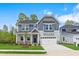 Charming two-story home featuring a well-maintained lawn, covered porch and attached two-car garage at 741 Aristocrat Ln, Knightdale, NC 27545