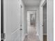 Bright hallway featuring modern tile flooring leading to a bathroom with glass-enclosed shower at 741 Aristocrat Ln, Knightdale, NC 27545