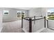 Bright upstairs hallway with natural light and railing overlooking the neighborhood, perfect for welcoming guests at 741 Aristocrat Ln, Knightdale, NC 27545