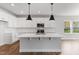 Modern kitchen featuring a large island, stainless steel appliances, and stylish pendant lighting fixtures at 741 Aristocrat Ln, Knightdale, NC 27545