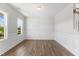 Bright, open living room with hardwood flooring, white trim, wainscotting, and plenty of natural light at 741 Aristocrat Ln, Knightdale, NC 27545