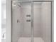 Close up of a shower with gray tile surround and glass doors, in this Primary bathroom at 741 Aristocrat Ln, Knightdale, NC 27545