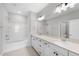 Bathroom with double sink vanity, large mirror, and separate tub and shower at 84 Ripple Way # 313, Clayton, NC 27520