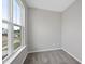 Bright bedroom features neutral walls, plush carpeting, and a large window with neighborhood views at 84 Ripple Way # 313, Clayton, NC 27520