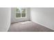 Comfortable bedroom featuring a large window, neutral walls, and plush carpeting for a relaxing atmosphere at 84 Ripple Way # 313, Clayton, NC 27520