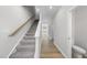 Bright hallway features carpeted stairs, hardwood floors and neutral paint tones at 84 Ripple Way # 313, Clayton, NC 27520
