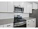 Close up on stainless steel oven, microwave and white subway tile backsplash at 84 Ripple Way # 313, Clayton, NC 27520