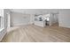 Open floor plan with hardwood floors connecting the kitchen and living room at 84 Ripple Way # 313, Clayton, NC 27520