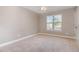 Bedroom with a large window, neutral walls, and carpeted floors at 89 Bison Ln, Lillington, NC 27546