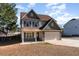 Charming two-story home featuring a well-manicured lawn and attached two-car garage at 89 Bison Ln, Lillington, NC 27546