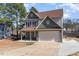 Charming two-story home with mature trees, a driveway, and an attached two-car garage at 89 Bison Ln, Lillington, NC 27546