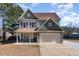 Charming two-story home features a well-maintained lawn and a two-car garage at 89 Bison Ln, Lillington, NC 27546