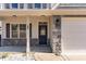 Charming home exterior with stone accents, covered porch, and well-maintained landscaping at 89 Bison Ln, Lillington, NC 27546