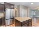 Modern kitchen island with granite countertops and stainless steel appliances at 89 Bison Ln, Lillington, NC 27546
