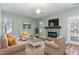 Inviting living room with fireplace, ceiling fan, and comfortable seating arrangement at 89 Bison Ln, Lillington, NC 27546
