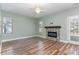 Spacious living room with hardwood floors, a stone fireplace, and access to the backyard at 89 Bison Ln, Lillington, NC 27546
