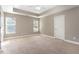 Large main bedroom featuring tray ceiling, a ceiling fan and natural light at 89 Bison Ln, Lillington, NC 27546