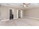 Spacious main bedroom with tray ceiling, ceiling fan, and ensuite bathroom at 89 Bison Ln, Lillington, NC 27546