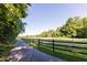 Paved pathway with split rail fence going into the distance at 905 Myers Point Dr, Morrisville, NC 27560