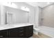 Bathroom with double vanity, black cabinets, quartz counters, shower with tile and soaker tub at 905 Myers Point Dr, Morrisville, NC 27560