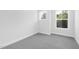 Bright bedroom with gray carpet and two large windows at 905 Myers Point Dr, Morrisville, NC 27560